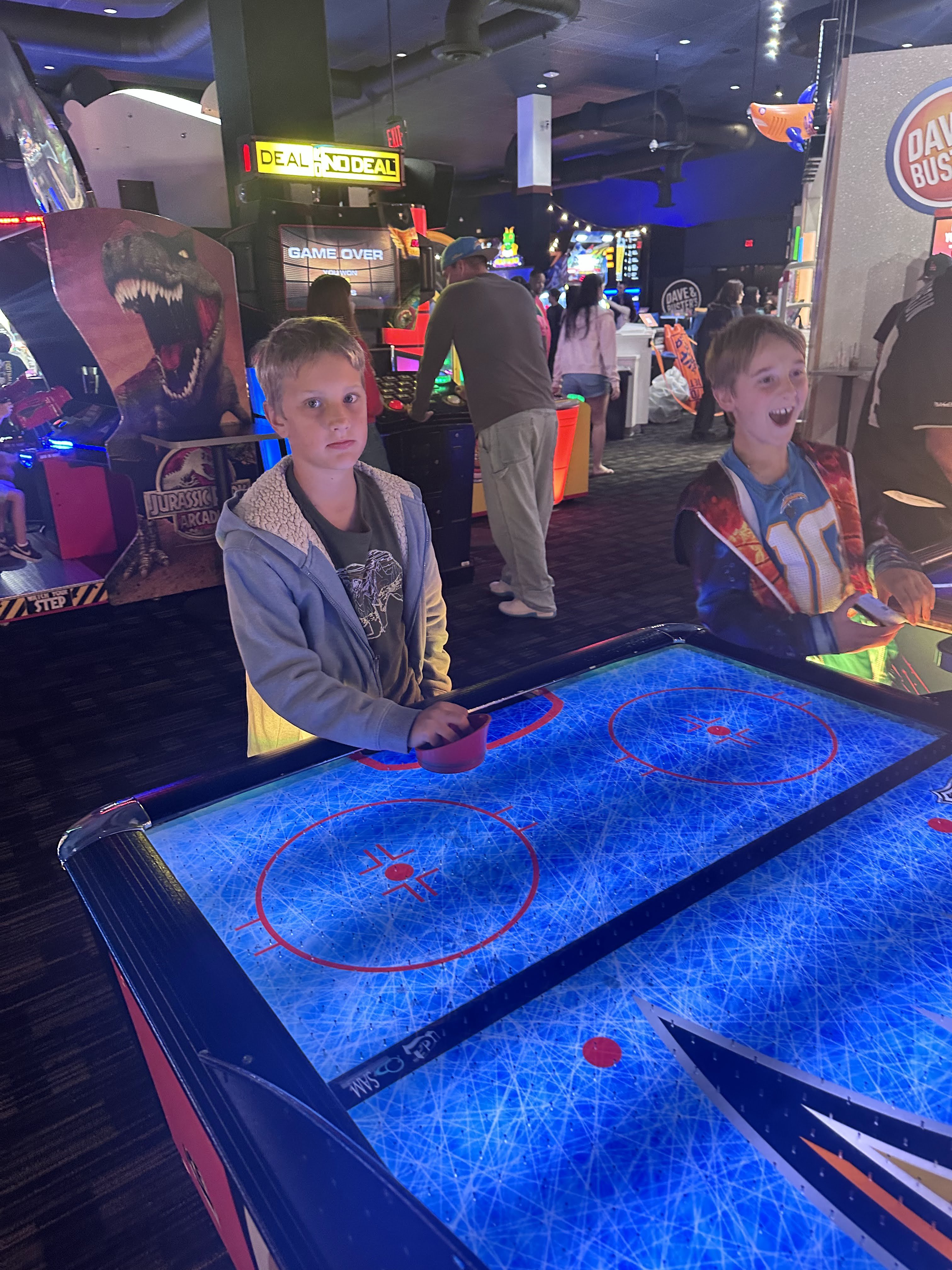Students playing air hockey at an MBMA Parents Group event