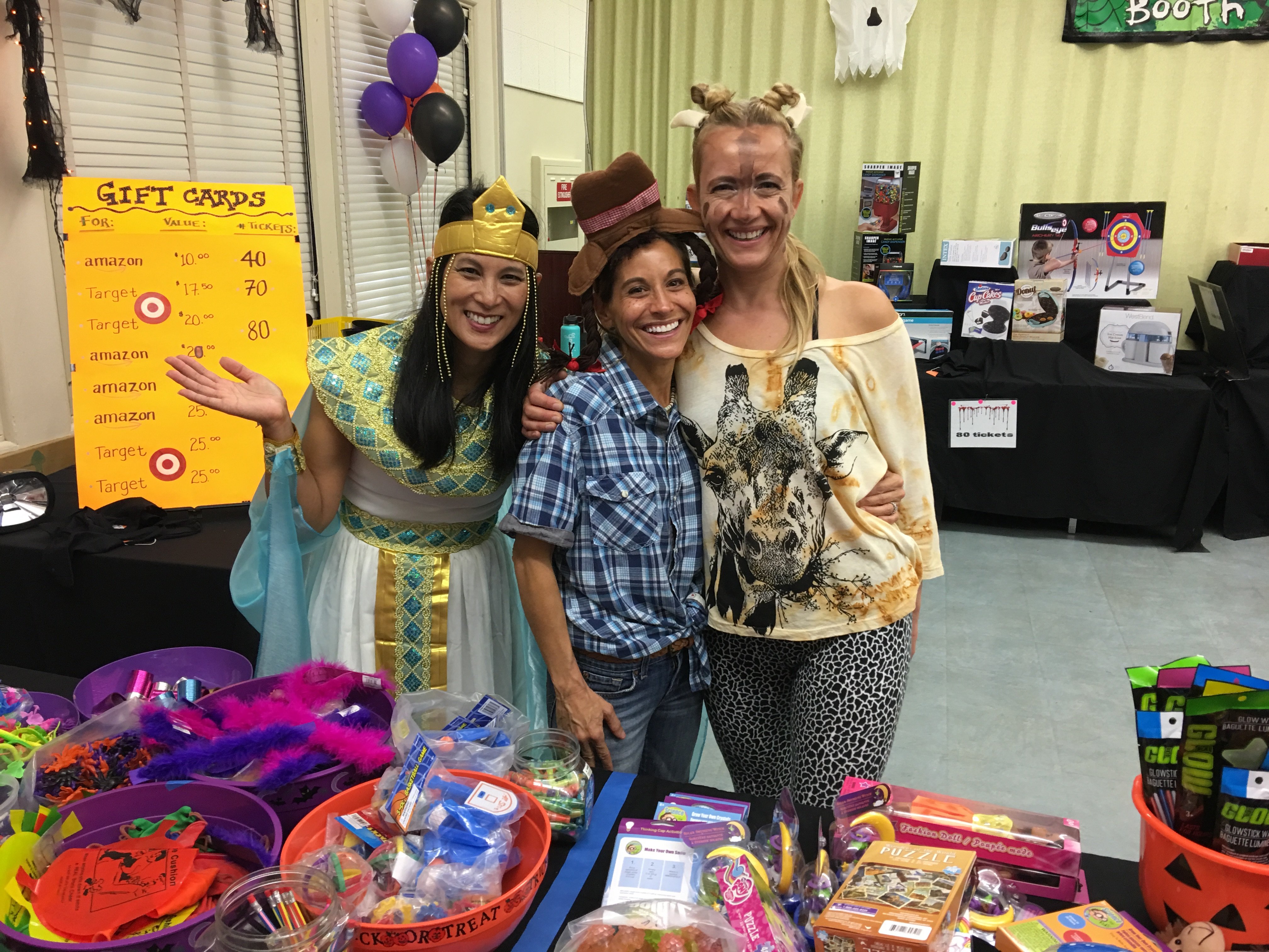 Volunteers at an MBMA Halloween prize booth