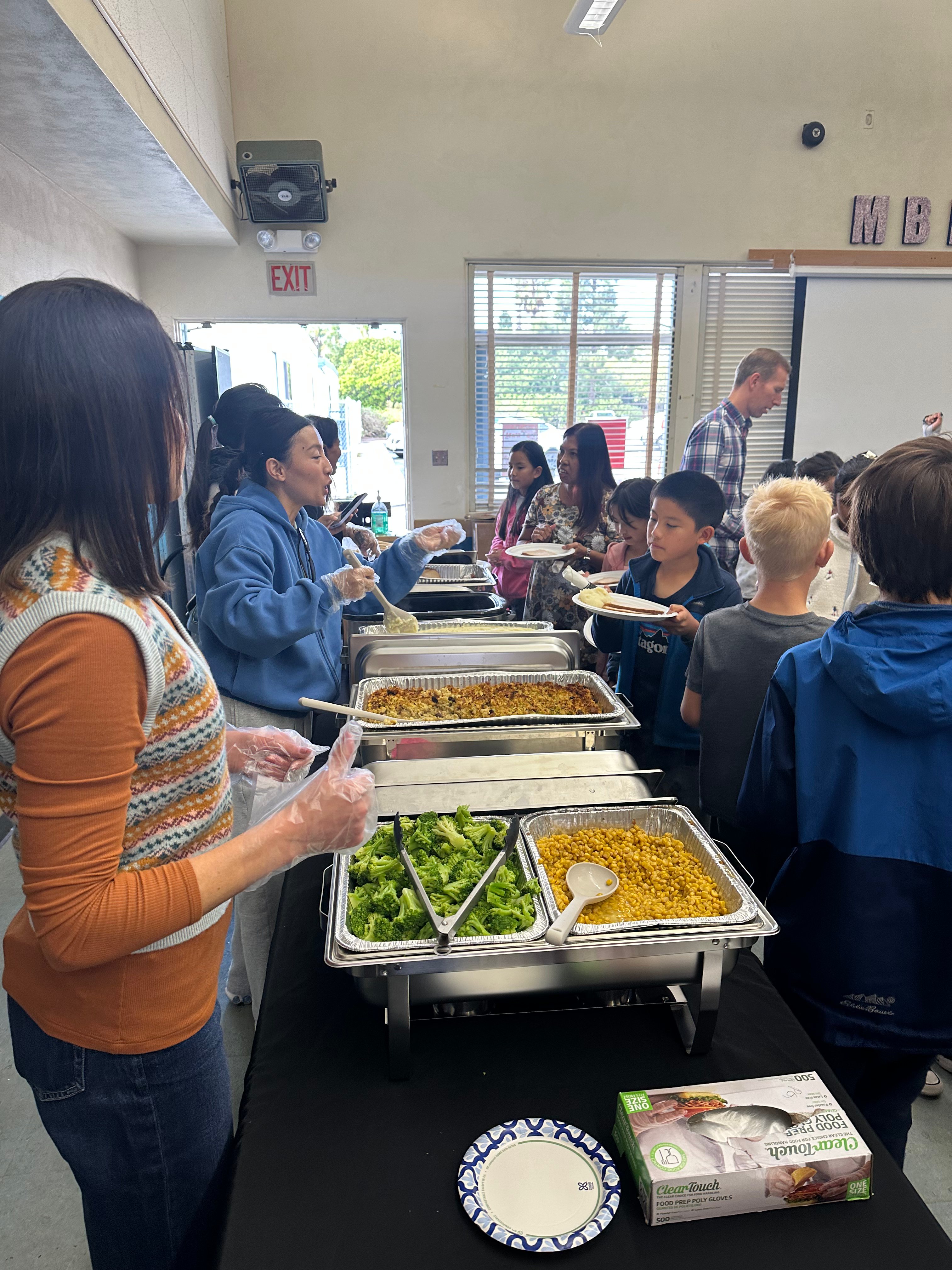 Students and volunteers at an MBMA holiday meal
