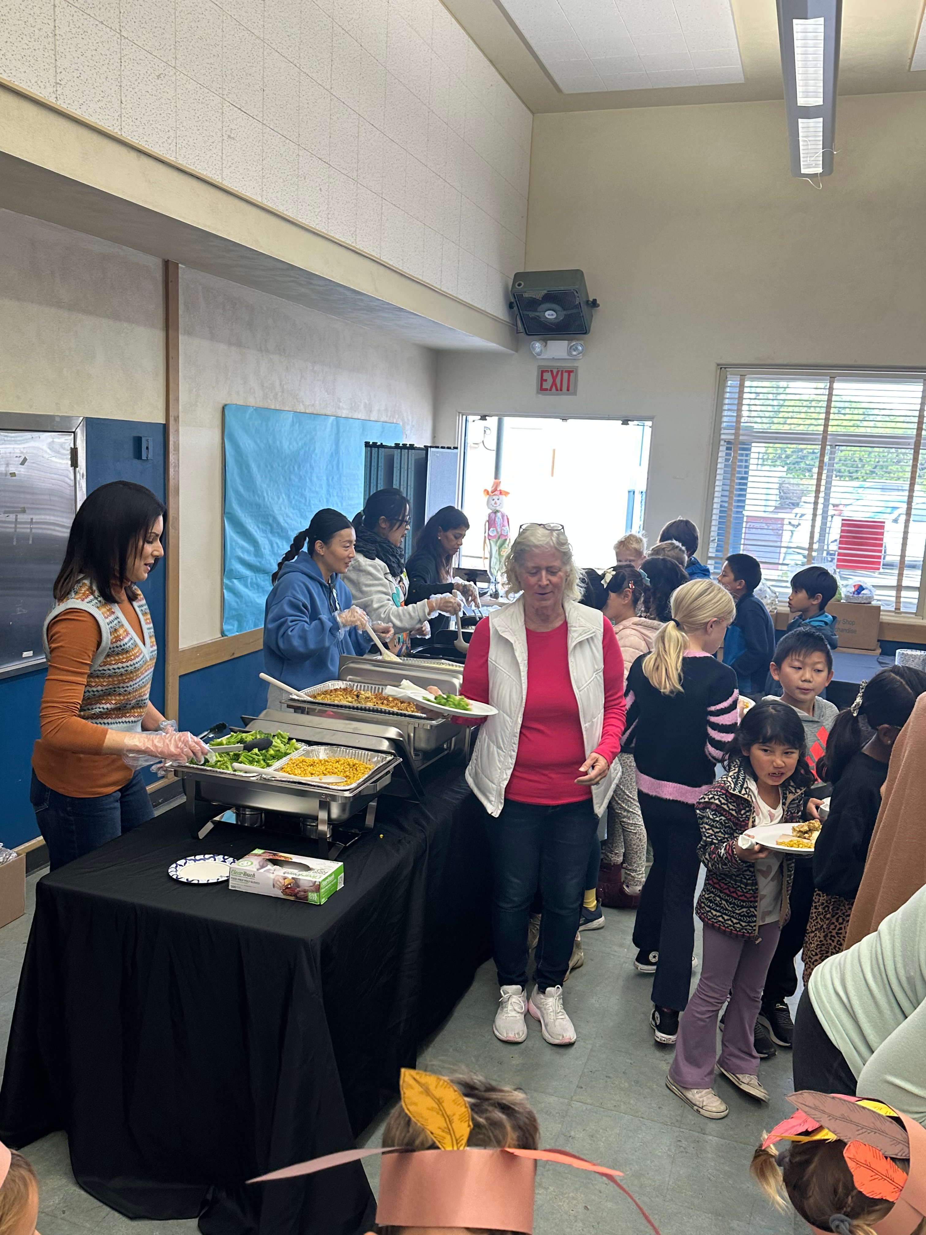 Volunteers serving a holiday meal at MBMA
