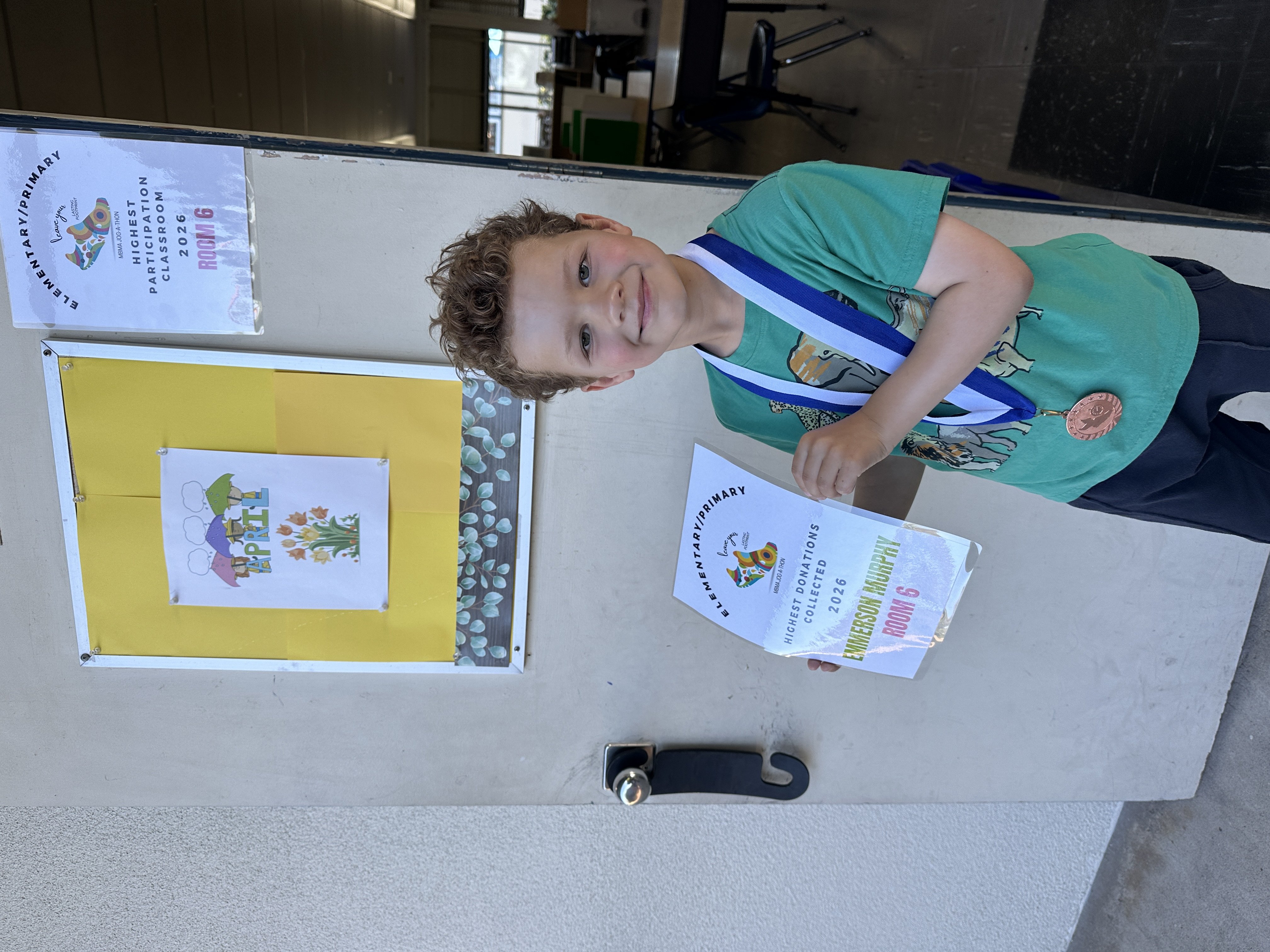 A student with a Jog-A-Thon award at MBMA